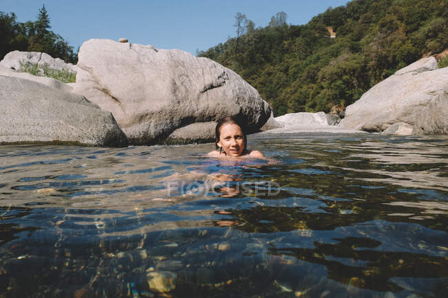Tween Boy Lounges in a Shallow River in the Mid Summer Heat — Stock Photo
