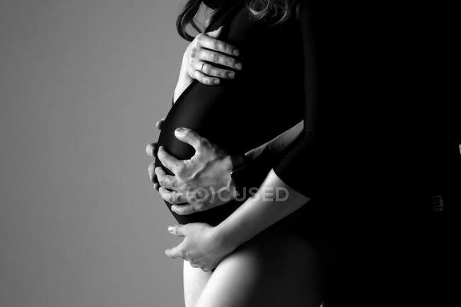 Husband and wife hold their stomachs during pregnancy — Stock Photo