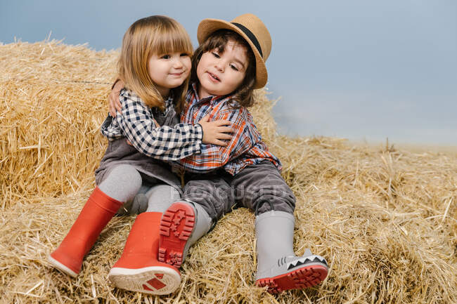 Cute little girls on a haystack — Stock Photo