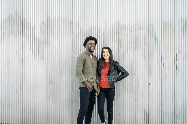 Fashionable Mixed Ethnicity Couple Leaning On Each Other — Stock Photo
