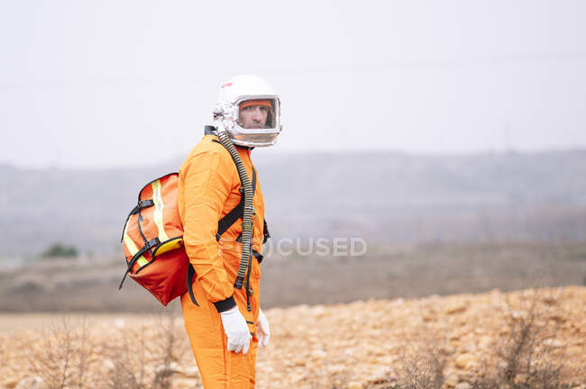 Man dressed as an astronaut with a bag isolated — Stock Photo