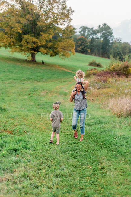 Two little kids and their grandmother on a nature walk in New England — Stock Photo