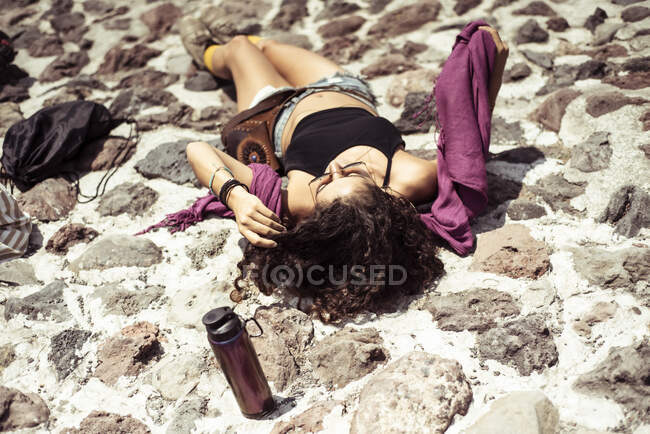 Sorting attractive healthy young tan Mexican sun baking on Stone — Stock Photo