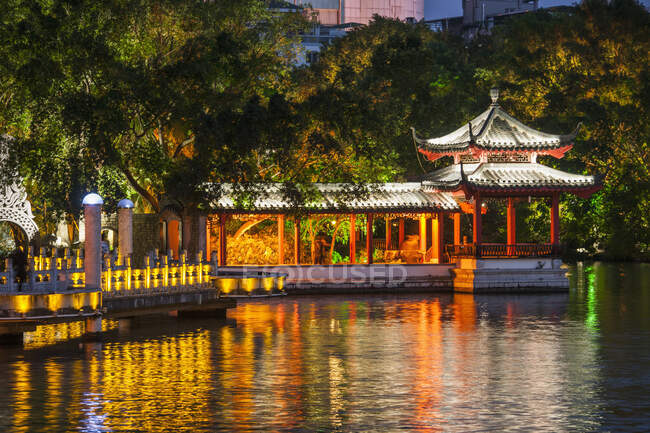 Authentic chinese pagoda and bridge illuminated at night — Stock Photo