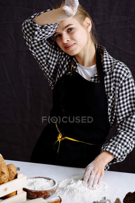 Girl makes bread dough in a kitchen — Stock Photo