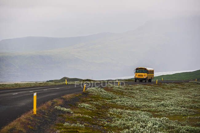 School bus on rural road in Iceland — Stock Photo