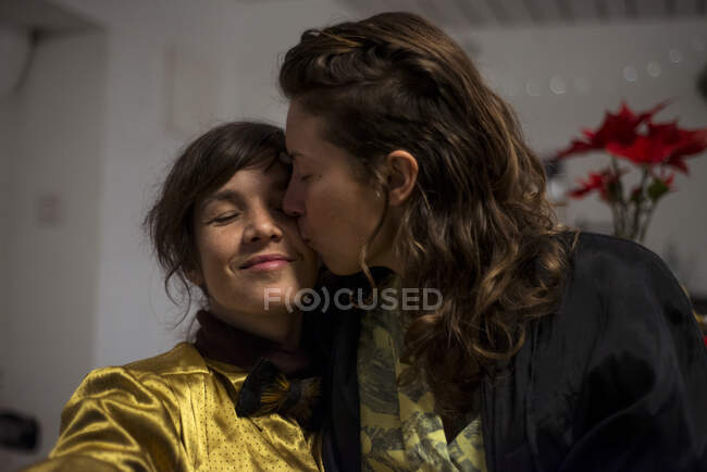 Gay lésbicas casal abraço e sorriso no casa durante jantar festa — Fotografia de Stock