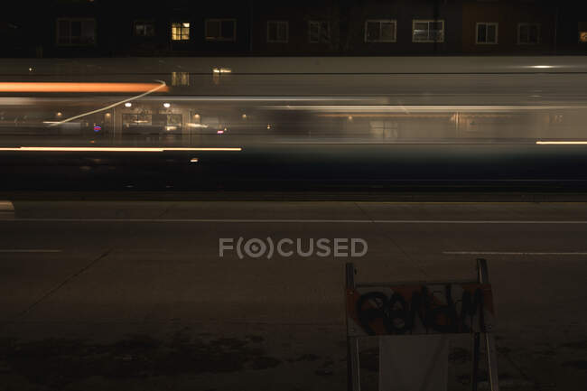 Fast Passenger Train Moves Through a Street at Night (Motion Blur) B — Stock Photo