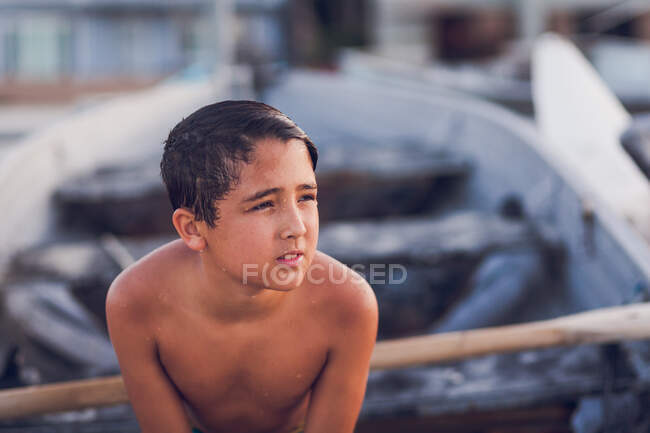 Portrait of a young boy by boat — Stock Photo