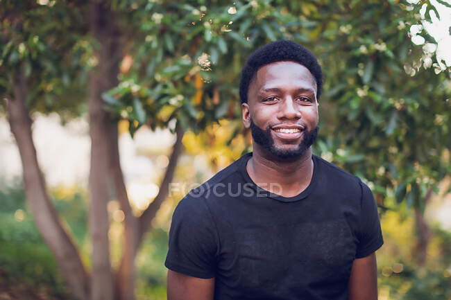 A young african american male standing alone in the park — Stock Photo