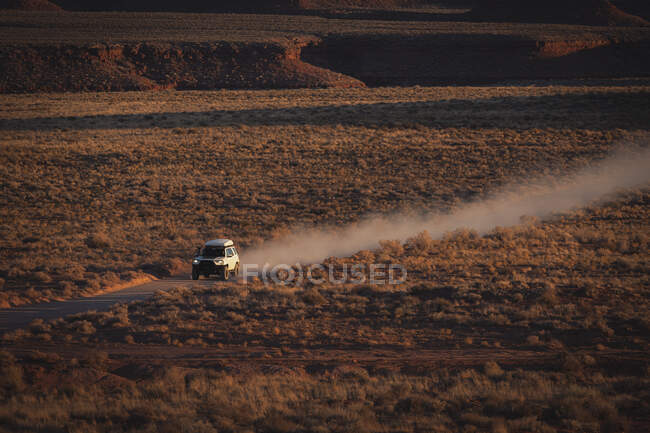Off-road vehicle moving on dirt road at desert — Stock Photo