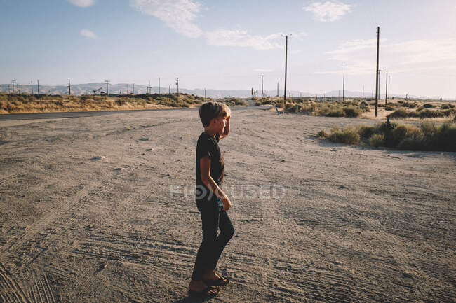 Boy mira a través de campos petroleros de Maricopa - foto de stock
