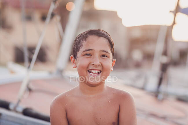 Portrait of a young boy by boat — Stock Photo