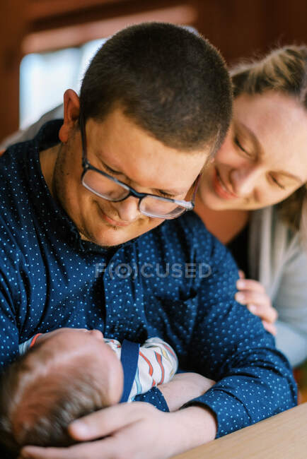 A new father and mother looking at their new baby boy together — Stock Photo
