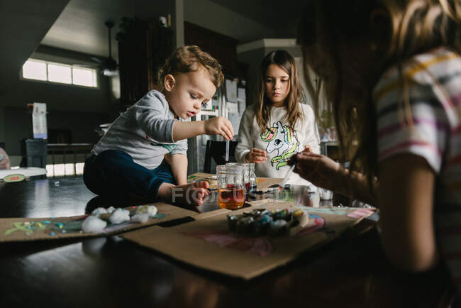 Kids working on an art project at home making fish during homeschool — Stock Photo