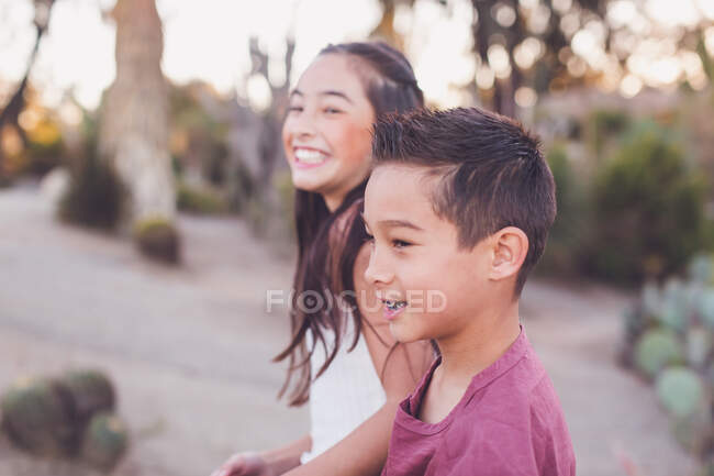Smiling brother and sister, focus on brother. — Stock Photo