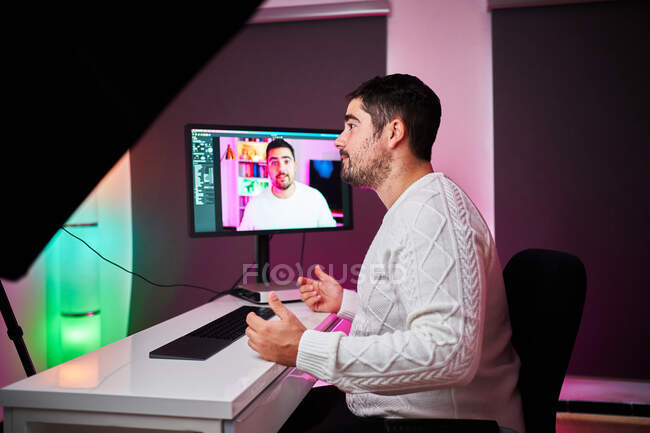 Young streamer on a room with multicolor lights — Stock Photo