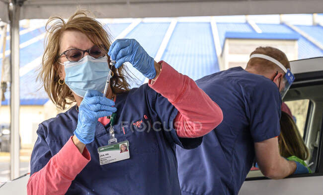 Uma enfermeira prepara uma seringa em um centro de distribuição de vacinas em Hoover, Alabama, organizado pela Universidade do Alabama, Birmingham, UAB. — Fotografia de Stock