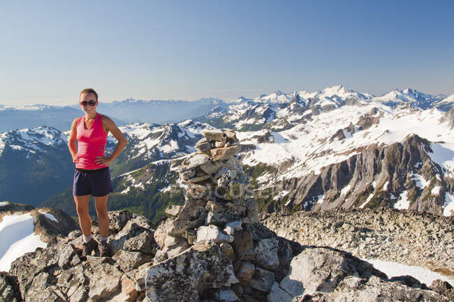Portrait of attractive female trail runner on mountain summit, Canada — Stock Photo