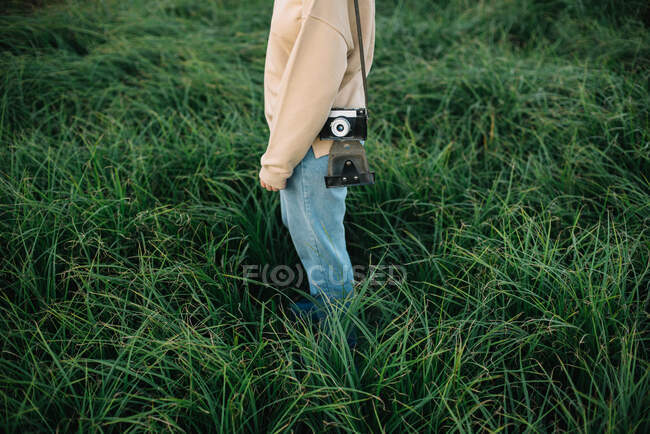 Красуня тримає кінокамеру в полі. — стокове фото