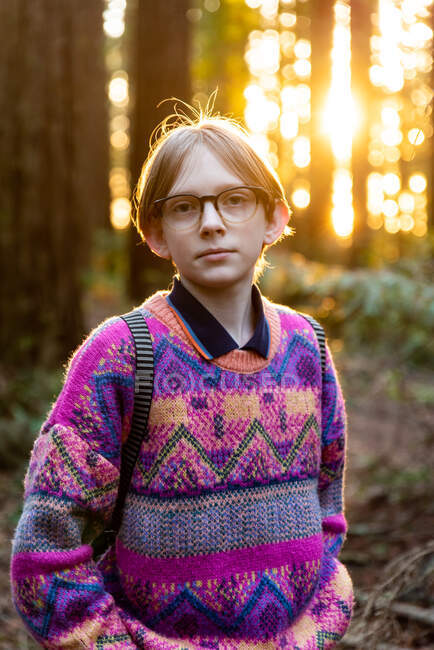 Portrait of calm young person looking at camera in redwood grove — Stock Photo