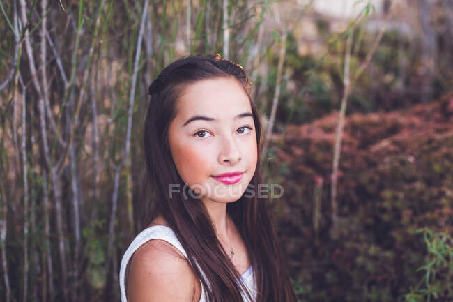 Pre-teen girl of mixed race, Asian and Caucasian looking at the camera — Stock Photo