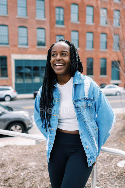 Young happy and laughing black woman in New England city downtown area — Stock Photo
