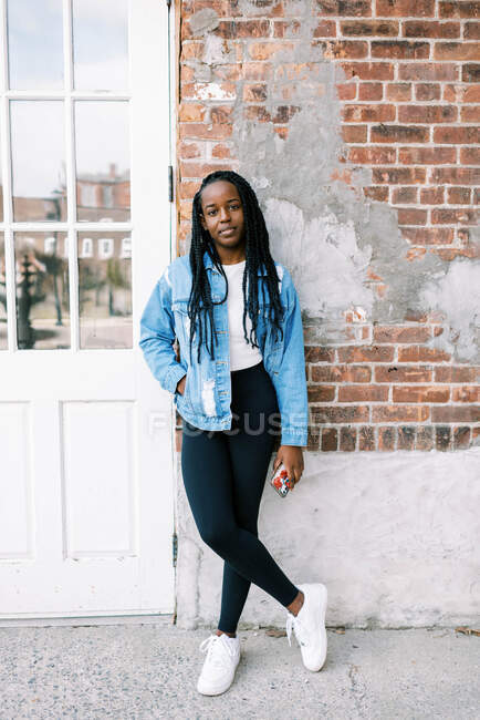 Portrait headshot of beautiful young black woman in jean jacket — Stock Photo