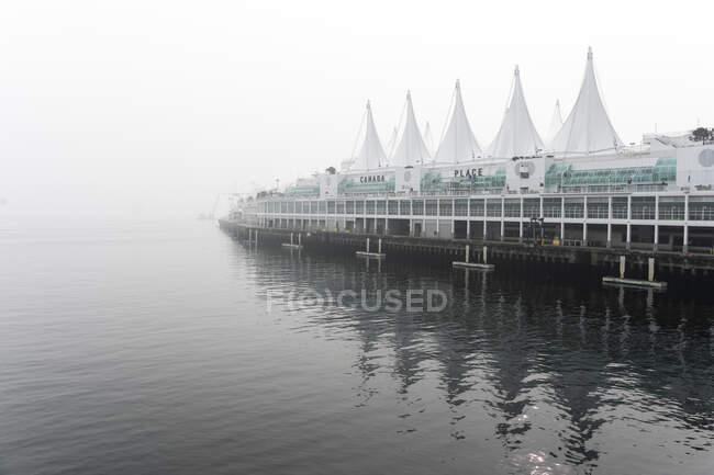 Canada Place at waters edge in Vancouver on foggy day — Stock Photo
