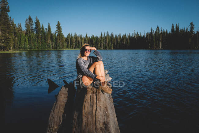 Blonde Woman on Sierra Lake Shields her Eyes from the Sun — Stock Photo
