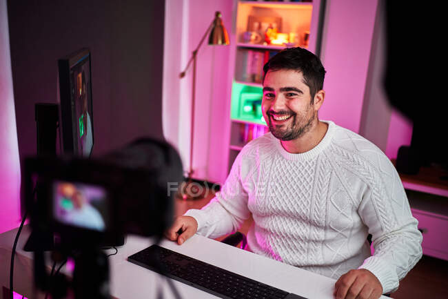 Young streamer on a room with multicolor lights — Stock Photo