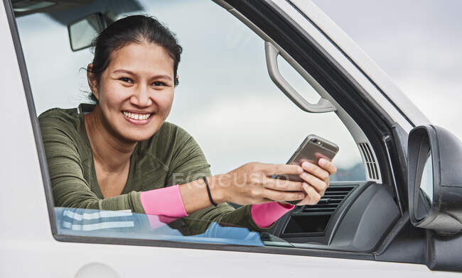 Young woman with mobile phone and smartphone — Stock Photo