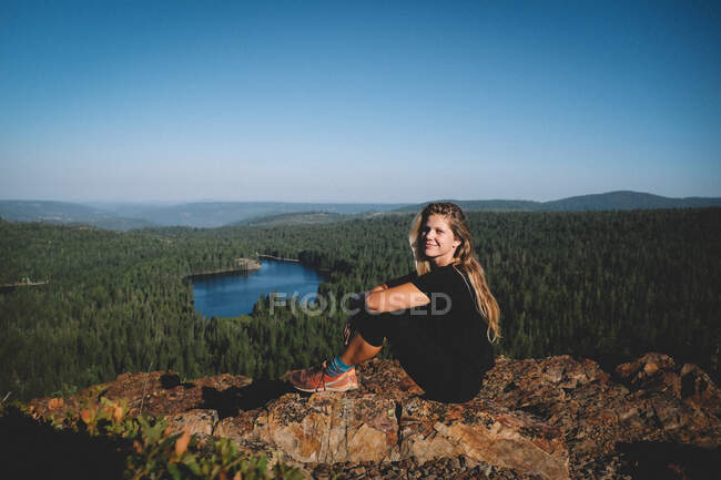 Woman With Long Blonde Hair Poses at Sunrise above Scenic Lake — Stock Photo