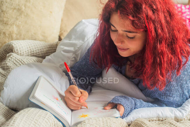 Gen Z writing in her journal — Stock Photo