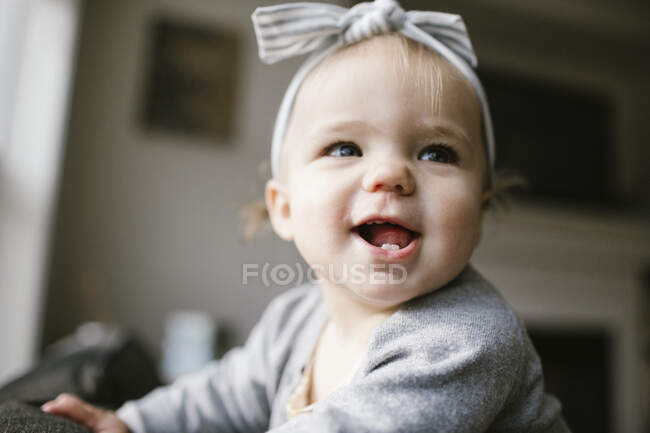 Close up of happy one year old smiling at home. — Stock Photo