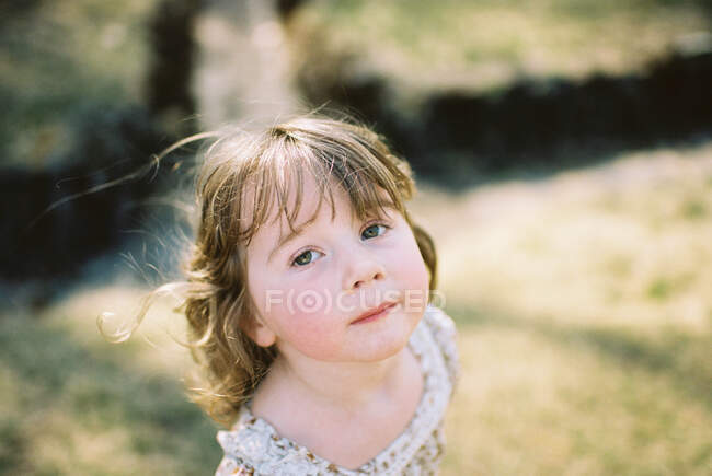 Little girl looking tired from a nature walk on a sunny day — Stock Photo