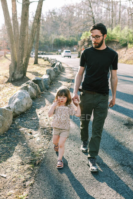 A father and his father walking to the car together after a hike — Stock Photo