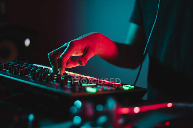 Close up of Dj hands mixing and adjusting volume — Stock Photo