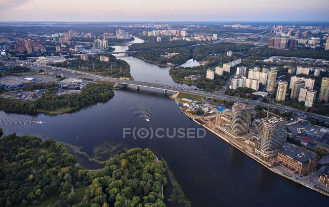 Aerial view of town and river flowing in the middle under highway — Stock Photo