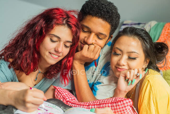 Trio of Friends doodling in journal — Stock Photo