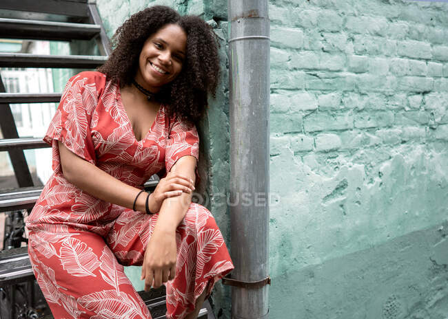 Attractive female African American with curly hair, in a red dre — Stock Photo