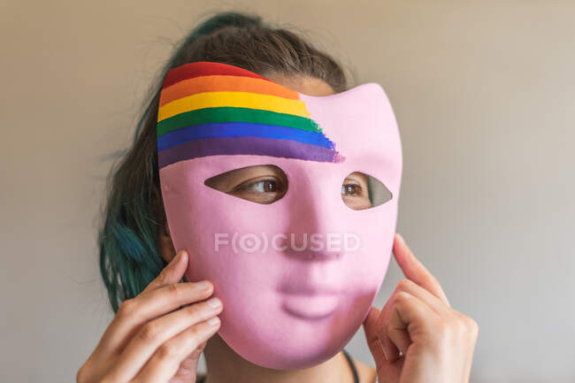 Mulher se preparando para o dia do orgulho com máscara artesanal com bandeira LGBTI — Fotografia de Stock