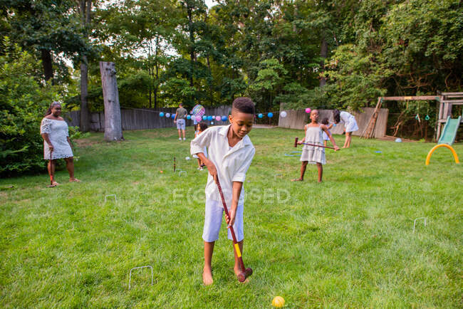 Children playing cricket at lawn party — Stock Photo