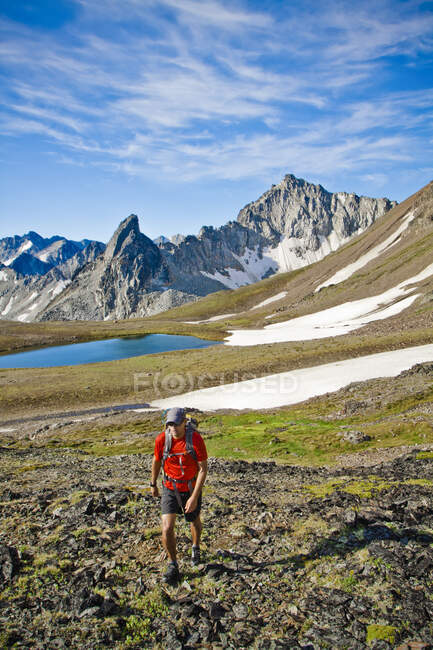 Backpacker hiking through beautiful scenic landscape in B.C. Canada. — Stock Photo