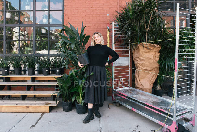 Small business owner of plant shop holding a new shipment of plants — Stock Photo