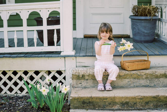 Маленькая девочка с букетом цветов — стоковое фото