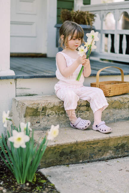 Маленька дівчинка з букетом квітів — стокове фото