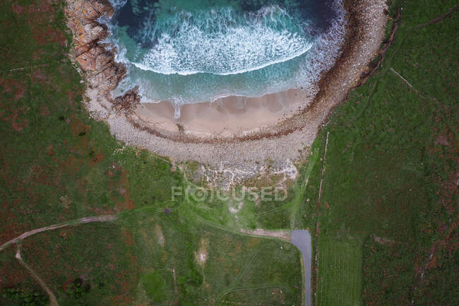 Drone vista superior de una playa salvaje con paisaje verde en Galicia, España - foto de stock