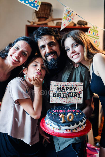 Portrait of a Latino family celebrating little girl's 10th birthday — Stock Photo