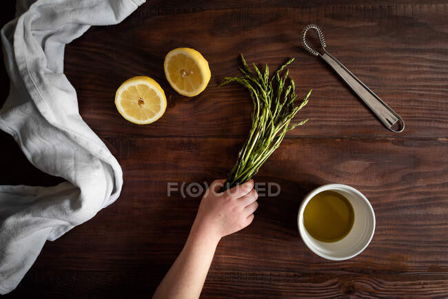 Frau hans mit Gras und Tee auf Holztisch — Stockfoto